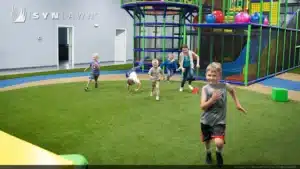 kida playing on playground artificial grass lawn in West Palm Beach, FL